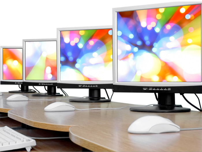 Image of computer monitors on a desk. 